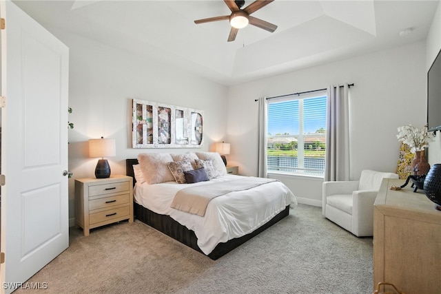 3387 Pilot Cir, Naples, FL 34120 - bedroom featuring a tray ceiling, light colored carpet, and a ceiling fan