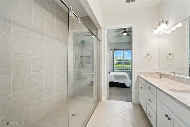 3387 Pilot Cir, Naples, FL 34120 - bathroom with double vanity, a tile shower, ensuite bath, a ceiling fan, and tile patterned flooring