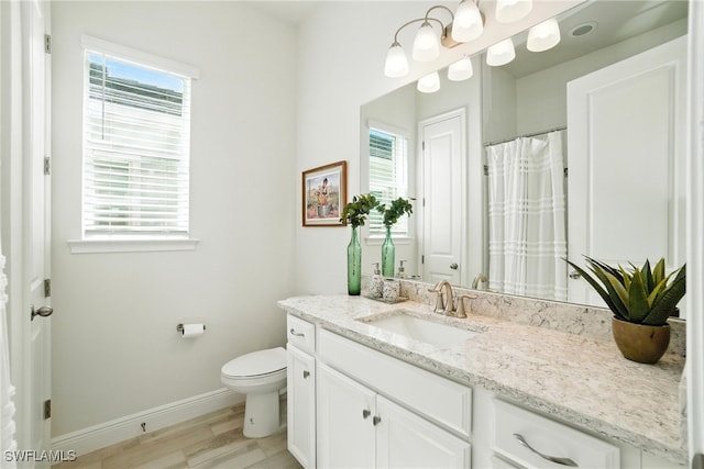 3387 Pilot Cir, Naples, FL 34120 - bathroom with healthy amount of natural light, vanity, and wood finished floors