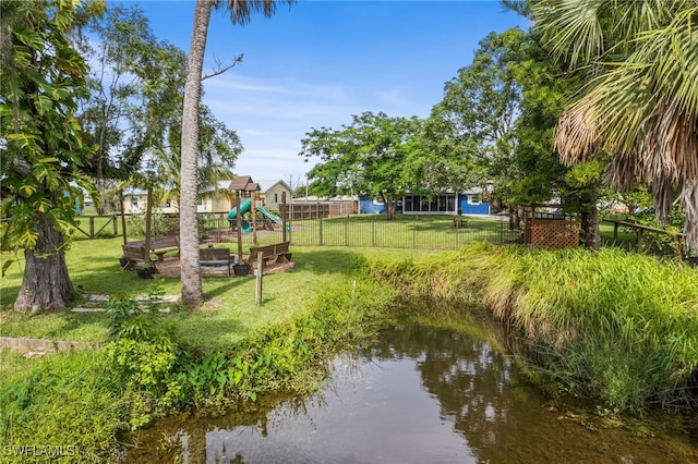 4811 Shady River Ln, Fort Myers, FL 33905 - dock area featuring a playground, a fenced backyard, and a water view