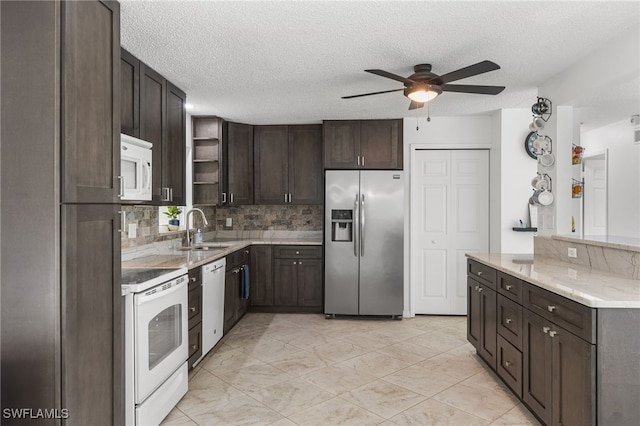 4811 Shady River Ln, Fort Myers, FL 33905 - kitchen with white appliances, ceiling fan, open shelves, dark brown cabinetry, and tasteful backsplash