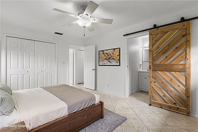 4811 Shady River Ln, Fort Myers, FL 33905 - bedroom with a barn door, a closet, ceiling fan, connected bathroom, and crown molding