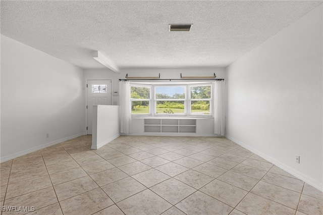 4811 Shady River Ln, Fort Myers, FL 33905 - spare room featuring a textured ceiling and light tile patterned floors