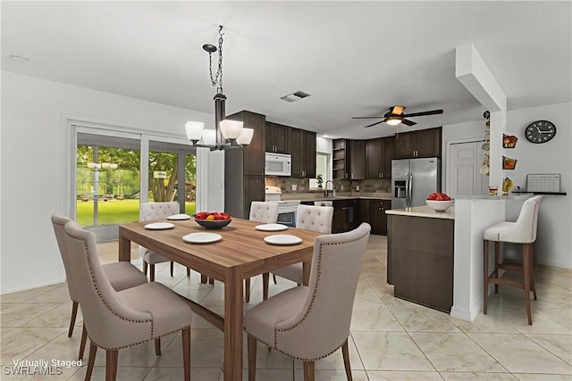 4811 Shady River Ln, Fort Myers, FL 33905 - dining room with a chandelier, a ceiling fan, and light tile patterned floors