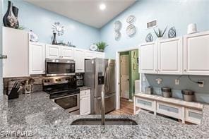 1843 Landale Loop, Lehigh Acres, FL 33972 - kitchen featuring stainless steel appliances, backsplash, white cabinets, light stone countertops, and recessed lighting