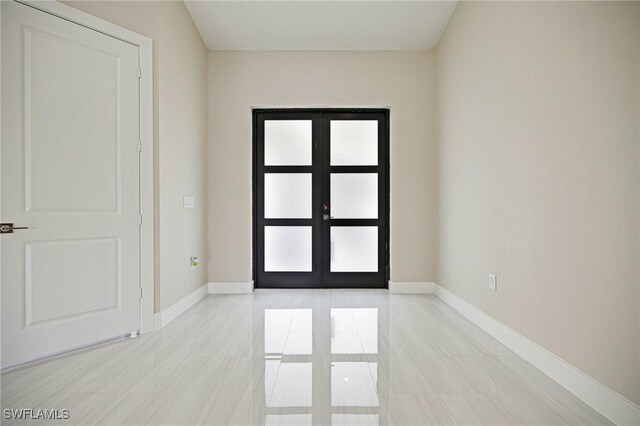 1117 SW Trafalgar Pkwy, Cape Coral, FL 33991 - entryway with french doors and light tile patterned floors