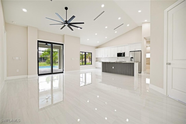1117 SW Trafalgar Pkwy, Cape Coral, FL 33991 - unfurnished living room with a ceiling fan, light tile patterned flooring, recessed lighting, and high vaulted ceiling