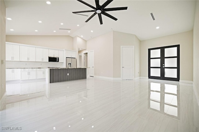 1117 SW Trafalgar Pkwy, Cape Coral, FL 33991 - kitchen with stainless steel appliances, open floor plan, white cabinetry, recessed lighting, and ceiling fan