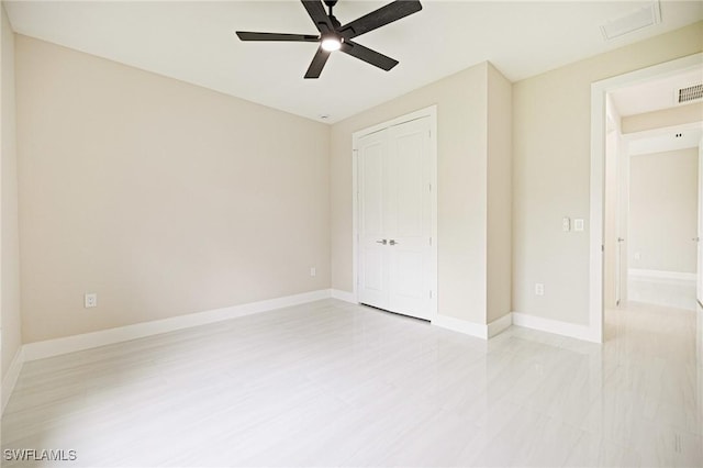 1117 SW Trafalgar Pkwy, Cape Coral, FL 33991 - unfurnished bedroom featuring a closet, a ceiling fan, attic access, and light wood-style floors