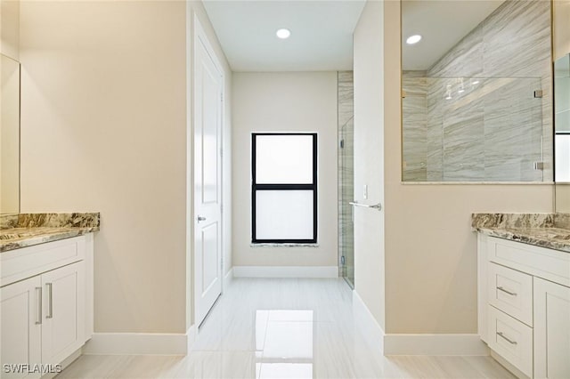 1117 SW Trafalgar Pkwy, Cape Coral, FL 33991 - full bathroom with two vanities, tiled shower, and recessed lighting