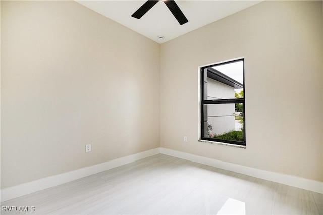 1117 SW Trafalgar Pkwy, Cape Coral, FL 33991 - empty room with a ceiling fan and baseboards