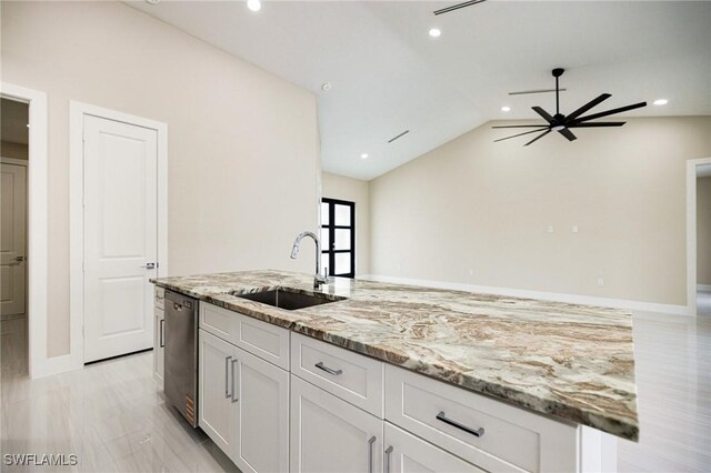 1117 SW Trafalgar Pkwy, Cape Coral, FL 33991 - kitchen featuring stainless steel dishwasher, ceiling fan, white cabinetry, light stone countertops, and lofted ceiling