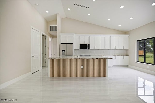 1328 SW 22nd Pl, Cape Coral, FL 33991 - kitchen with appliances with stainless steel finishes, a kitchen island with sink, backsplash, white cabinets, and recessed lighting
