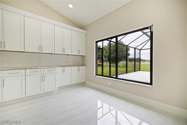 1328 SW 22nd Pl, Cape Coral, FL 33991 - unfurnished dining area with vaulted ceiling and light tile patterned flooring