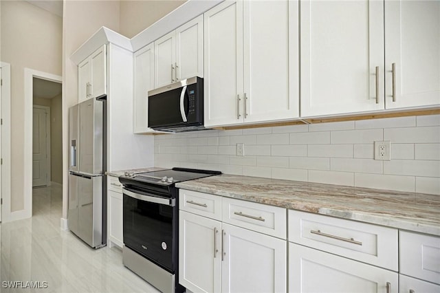 1328 SW 22nd Pl, Cape Coral, FL 33991 - kitchen featuring stainless steel appliances, white cabinetry, decorative backsplash, and light stone countertops