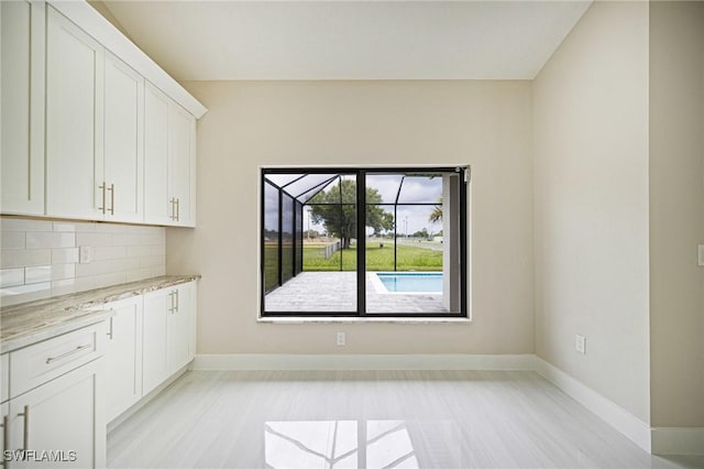 1328 SW 22nd Pl, Cape Coral, FL 33991 - unfurnished dining area featuring baseboards