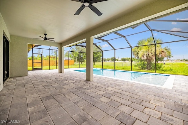 1328 SW 22nd Pl, Cape Coral, FL 33991 - swimming pool featuring a ceiling fan, a patio area, glass enclosure, and a lawn