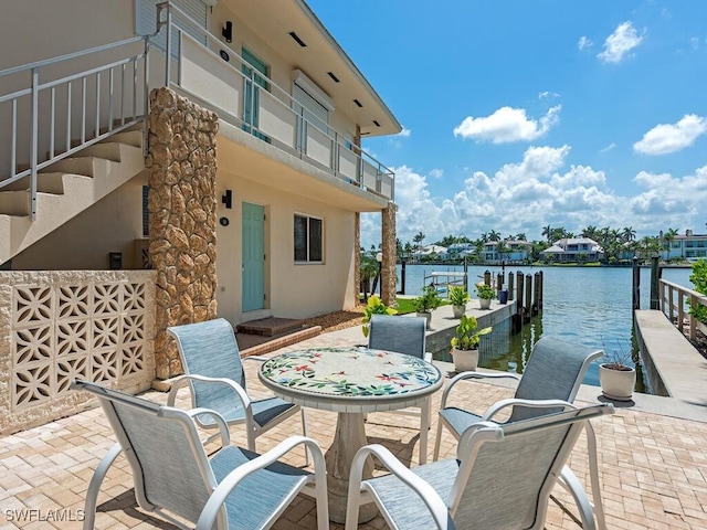2500 Gulf Shore Blvd N Unit S9, Naples, FL 34103 - view of patio / terrace featuring a water view, a boat dock, and outdoor dining space