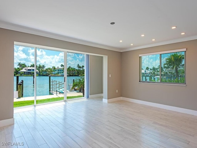 2500 Gulf Shore Blvd N Unit S9, Naples, FL 34103 - spare room featuring crown molding, a water view, light wood-style floors, and recessed lighting