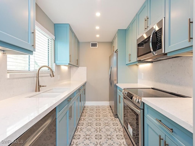 2500 Gulf Shore Blvd N Unit S9, Naples, FL 34103 - kitchen with appliances with stainless steel finishes, blue cabinetry, and recessed lighting