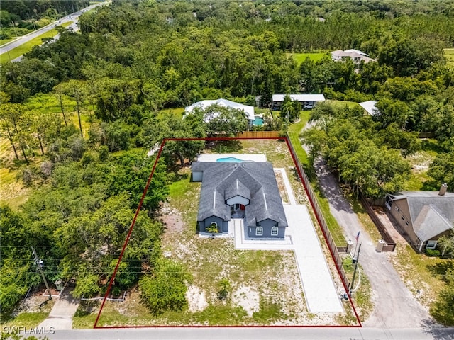 4868 Chisholm Park Trl, Saint Cloud, FL 34771 - aerial view of property and surrounding area featuring property parcel outlined and a forest