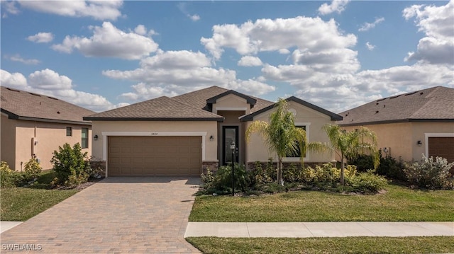3440 Menores Way, Fort Myers, FL 33905 - ranch-style home featuring stucco siding, a garage, decorative driveway, a front lawn, and stone siding