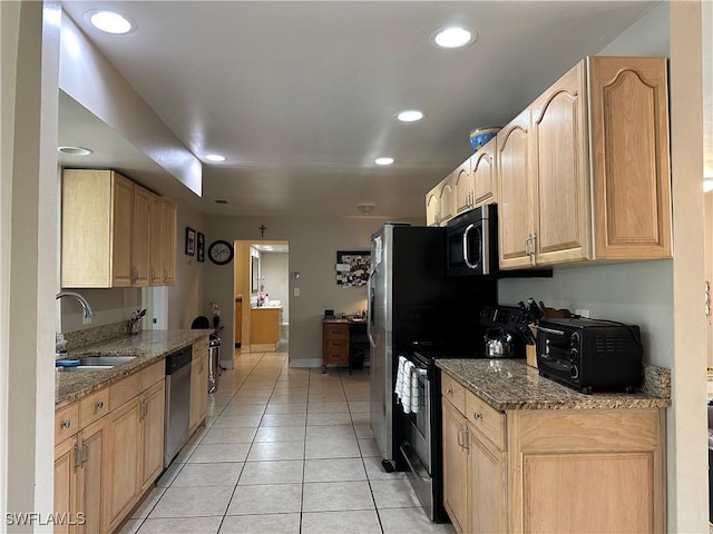 4620 Parrot Ave, Naples, FL 34104 - kitchen featuring appliances with stainless steel finishes, light tile patterned floors, dark stone counters, recessed lighting, and light brown cabinetry