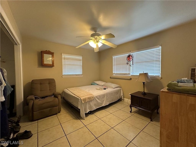 4620 Parrot Ave, Naples, FL 34104 - bedroom featuring light tile patterned flooring, multiple windows, a closet, and a ceiling fan