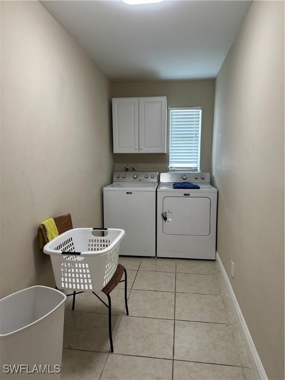 4620 Parrot Ave, Naples, FL 34104 - laundry room featuring cabinet space, washing machine and clothes dryer, and light tile patterned flooring