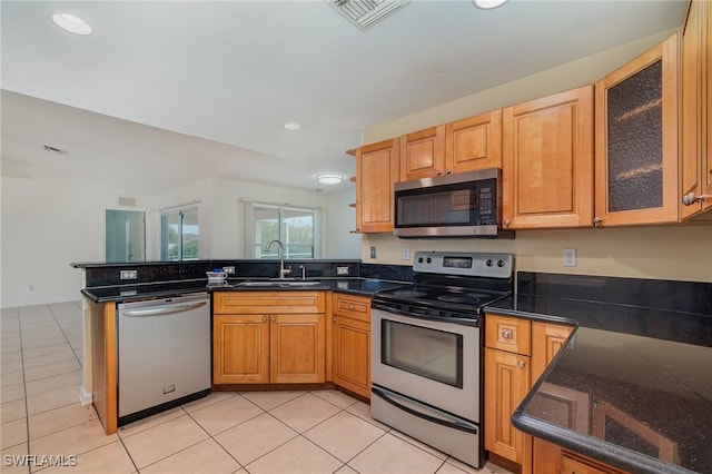 3213 22nd St SW, Lehigh Acres, FL 33976 - kitchen with stainless steel appliances, a peninsula, light tile patterned floors, glass insert cabinets, and recessed lighting