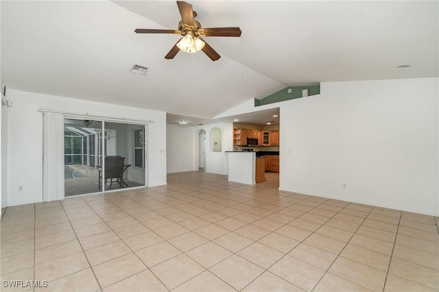 3213 22nd St SW, Lehigh Acres, FL 33976 - unfurnished living room with vaulted ceiling, a ceiling fan, and arched walkways