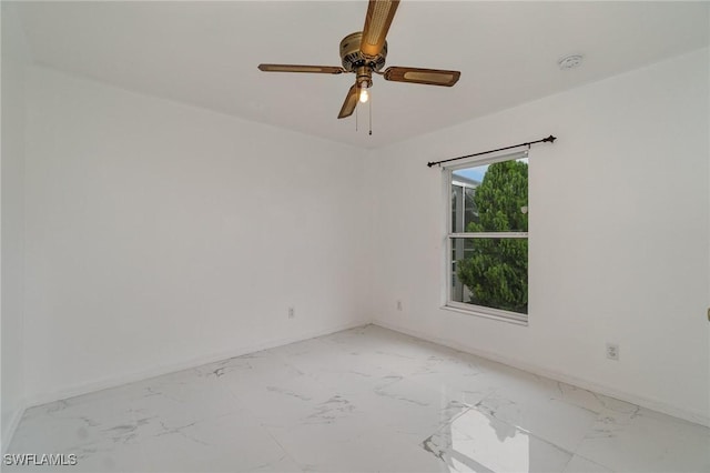 3213 22nd St SW, Lehigh Acres, FL 33976 - spare room featuring light marble finish flooring and a ceiling fan