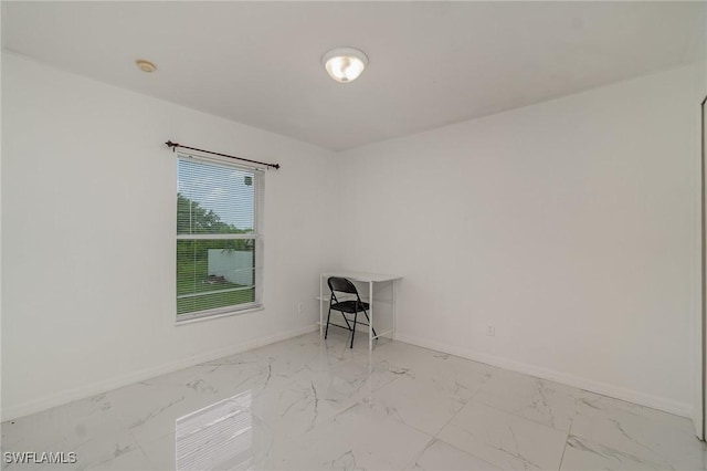 3213 22nd St SW, Lehigh Acres, FL 33976 - unfurnished room with marble look tiles and a smoke detector
