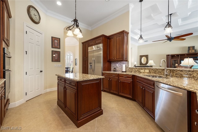 19332 La Serena Dr, Estero, FL 33967 - kitchen featuring stainless steel appliances, a ceiling fan, crown molding, pendant lighting, and backsplash