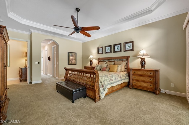 19332 La Serena Dr, Estero, FL 33967 - bedroom featuring arched walkways, light colored carpet, ornamental molding, a tray ceiling, and ceiling fan