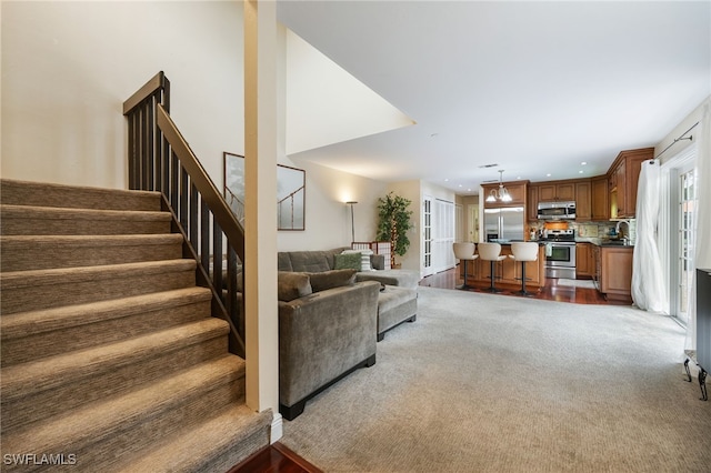 13660 Abbey Dr Unit 1, Fort Myers, FL 33919 - living area with dark colored carpet, stairway, and recessed lighting