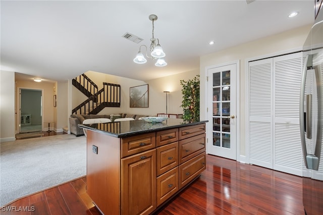 13660 Abbey Dr Unit 1, Fort Myers, FL 33919 - kitchen featuring dark wood-type flooring, open floor plan, pendant lighting, a chandelier, and brown cabinets