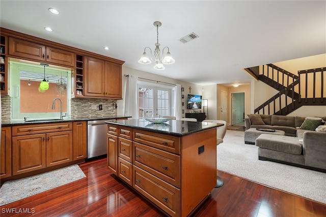 13660 Abbey Dr Unit 1, Fort Myers, FL 33919 - kitchen with stainless steel dishwasher, a chandelier, dark wood-style flooring, a center island, and decorative light fixtures