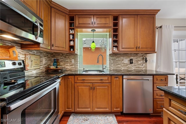 13660 Abbey Dr Unit 1, Fort Myers, FL 33919 - kitchen featuring stainless steel appliances, open shelves, brown cabinetry, dark stone countertops, and dark wood-style flooring