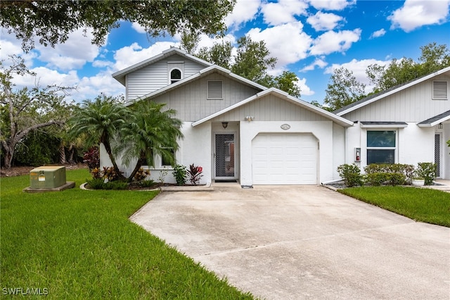 13660 Abbey Dr Unit 1, Fort Myers, FL 33919 - view of front of house with driveway, a front yard, and a garage