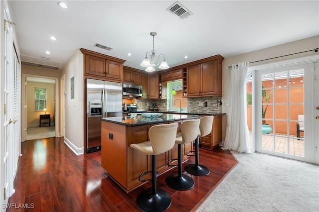 13660 Abbey Dr Unit 1, Fort Myers, FL 33919 - kitchen with stainless steel appliances, dark countertops, dark wood finished floors, recessed lighting, and decorative backsplash