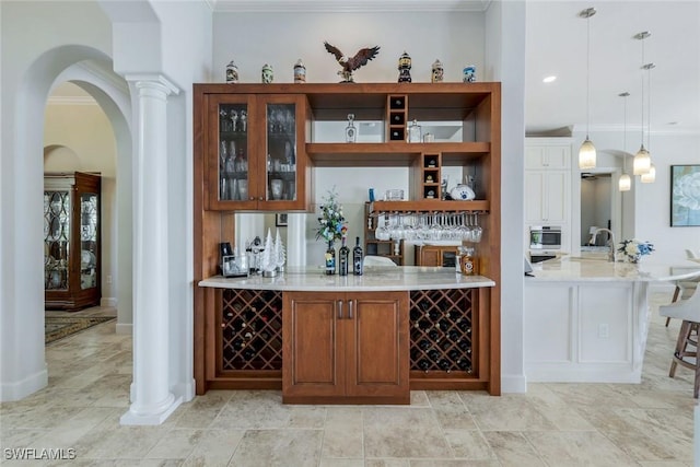 9380 Slate Ct, Naples, FL 34120 - indoor bar featuring ornamental molding, arched walkways, pendant lighting, and decorative columns