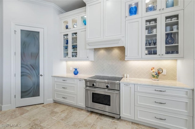 9380 Slate Ct, Naples, FL 34120 - kitchen with designer stove, tasteful backsplash, white cabinets, glass insert cabinets, and crown molding