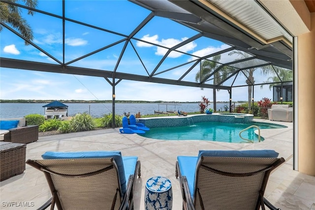 9380 Slate Ct, Naples, FL 34120 - view of pool featuring a patio area, a water view, glass enclosure, and a pool with connected hot tub