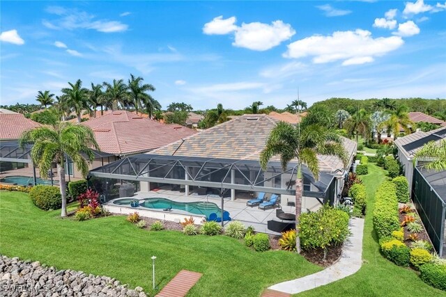 9380 Slate Ct, Naples, FL 34120 - rear view of property with a patio, a lawn, an outdoor pool, and a lanai