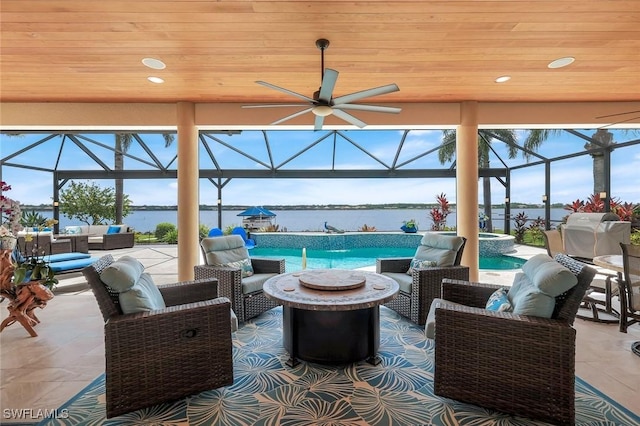 9380 Slate Ct, Naples, FL 34120 - view of patio with an outdoor living space with a fire pit, a water view, ceiling fan, and glass enclosure