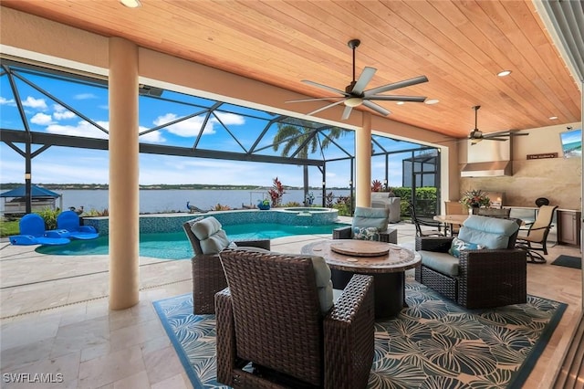 9380 Slate Ct, Naples, FL 34120 - view of patio featuring ceiling fan, a water view, outdoor dining area, a lanai, and a pool with connected hot tub