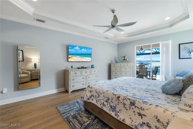 9380 Slate Ct, Naples, FL 34120 - bedroom featuring a raised ceiling, access to outside, wood finished floors, crown molding, and ceiling fan