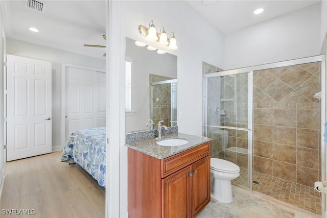9380 Slate Ct, Naples, FL 34120 - full bathroom featuring vanity, a shower stall, wood finished floors, and recessed lighting