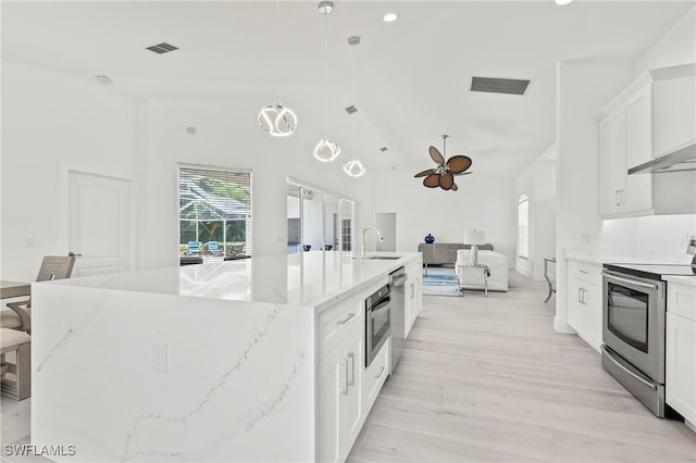 2050 Terrazzo Ln, Naples, FL 34104 - kitchen with stainless steel appliances, a ceiling fan, open floor plan, white cabinetry, and a spacious island